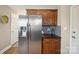 Kitchen featuring a stainless steel refrigerator, wood cabinets, and sleek countertops at 4301 Windjammer Sw Ct, Concord, NC 28027