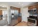 Charming kitchen with stainless steel fridge, oven, and microwave, plus stylish wood-look floors at 4301 Windjammer Sw Ct, Concord, NC 28027