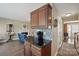 Kitchen with dark wood cabinets and black countertops, open to the living room and entryway at 4301 Windjammer Sw Ct, Concord, NC 28027