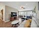 Spacious living room with wood floors, neutral decor, fireplace, and plenty of natural light at 4301 Windjammer Sw Ct, Concord, NC 28027