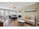 Cozy living room with wood flooring, fireplace, neutral walls, and lots of seating at 4301 Windjammer Sw Ct, Concord, NC 28027