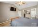 This main bedroom offers a ceiling fan and access to the main bathroom at 4301 Windjammer Sw Ct, Concord, NC 28027