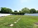 Expansive backyard featuring a lush lawn, stepping stones, and white fencing for privacy at 4562 Lanstone Sw Ct, Concord, NC 28027