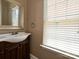 Bathroom featuring a stylish vanity, ample lighting, and modern fixtures that provide a luxurious feel at 4562 Lanstone Sw Ct, Concord, NC 28027