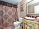 Well appointed bathroom with an ornate vanity, framed mirror, and decorative shower curtain at 4562 Lanstone Sw Ct, Concord, NC 28027