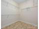 A walk-in closet with wire shelving and tile floors at 4562 Lanstone Sw Ct, Concord, NC 28027