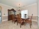 A dining room with traditional wood table, hutch, chandelier and paneled wall at 4562 Lanstone Sw Ct, Concord, NC 28027