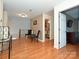 Open hallway features hardwood floors, decorative chairs, and an open doorway to another room at 4562 Lanstone Sw Ct, Concord, NC 28027