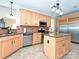 An eat-in kitchen featuring light wood cabinets, stainless steel appliances and an island at 4562 Lanstone Sw Ct, Concord, NC 28027