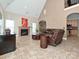 Cozy living room showcasing a fireplace, leather seating, and access to the kitchen at 4562 Lanstone Sw Ct, Concord, NC 28027