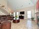Bright living room with large windows, a fireplace, and comfortable seating arrangements at 4562 Lanstone Sw Ct, Concord, NC 28027