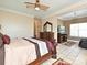 A traditional main bedroom featuring a four-poster bed and sitting area at 4562 Lanstone Sw Ct, Concord, NC 28027