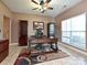 Elegant office featuring a large desk, built-in shelving, and natural light from a window at 4562 Lanstone Sw Ct, Concord, NC 28027