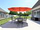 Inviting patio with an umbrella and dining set, perfect for outdoor entertaining and relaxation at 4562 Lanstone Sw Ct, Concord, NC 28027