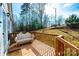 Spacious wooden porch offers a serene outdoor retreat with a comfortable bench and views of the lush green yard at 4845 Midway Sand Rd, Hickory, NC 28601