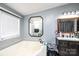 Bright bathroom features a tub, tile surround, vanity, and decorative mirrors at 4845 Midway Sand Rd, Hickory, NC 28601