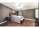 Bedroom featuring ceiling fan, wood floors, and dark grey wall color at 4845 Midway Sand Rd, Hickory, NC 28601