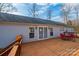 View of the house from the wooden deck, showcasing its sliding doors and outdoor dining area at 4845 Midway Sand Rd, Hickory, NC 28601