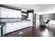 Open-concept kitchen featuring white cabinets, granite countertops, and hardwood floors, seamlessly flowing into the dining area at 4845 Midway Sand Rd, Hickory, NC 28601