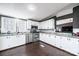 Bright kitchen with white cabinets, stainless steel appliances, and a stylish backsplash, designed for modern cooking at 4845 Midway Sand Rd, Hickory, NC 28601