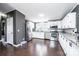 Well-equipped kitchen with stainless steel appliances, white cabinets, and dark hardwood floors, offering ample space at 4845 Midway Sand Rd, Hickory, NC 28601