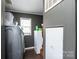Functional laundry room with washer, dryer, and mini fridge at 4845 Midway Sand Rd, Hickory, NC 28601