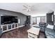 Spacious living room featuring wood floors, ceiling fan, and dark colored walls at 4845 Midway Sand Rd, Hickory, NC 28601