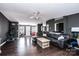 Living room with hardwood floors, dark walls, and comfortable seating area at 4845 Midway Sand Rd, Hickory, NC 28601