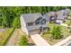 An aerial view of a well-maintained two-story home with lush lawn and mature trees on a sunny day at 5065 Watersail Way, Clover, SC 29710