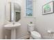Bathroom featuring pedestal sink, toilet and decorative mirror at 5065 Watersail Way, Clover, SC 29710