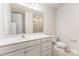 Well-lit bathroom with a single sink vanity, a large mirror, and a shower at 5065 Watersail Way, Clover, SC 29710
