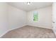 Bright bedroom with neutral carpet, white walls, and natural light from a single window at 5065 Watersail Way, Clover, SC 29710