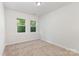 Bright bedroom with neutral carpet, white walls, and natural light from the windows at 5065 Watersail Way, Clover, SC 29710