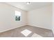 Bright bedroom with neutral carpet, white walls, and natural light from a single window at 5065 Watersail Way, Clover, SC 29710