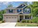 Charming two-story home with a large front yard, covered porch, and attached two-car garage at 5065 Watersail Way, Clover, SC 29710