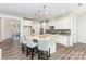 Modern kitchen with a large island, white cabinets, granite countertops, and pendant lighting at 5065 Watersail Way, Clover, SC 29710