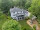 Aerial view of a home with a screened in porch, lush landscaping, backyard play set and large yard at 5135 Winding Brook Rd, Charlotte, NC 28226