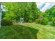 Lush backyard features mature trees, a play set and manicured lawn at 5135 Winding Brook Rd, Charlotte, NC 28226
