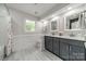 Well-lit bathroom with double vanity, neutral color scheme, and modern fixtures at 5135 Winding Brook Rd, Charlotte, NC 28226