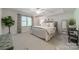 Serene bedroom features a plush bed, large windows and tasteful decor at 5135 Winding Brook Rd, Charlotte, NC 28226