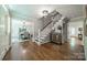 Elegant foyer featuring hardwood floors, staircase, and dining room view at 5135 Winding Brook Rd, Charlotte, NC 28226