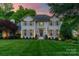 Charming two-story traditional home with manicured lawn, gray shutters and inviting front entrance at 5135 Winding Brook Rd, Charlotte, NC 28226