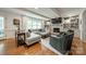 Bright living room with a fireplace, built-in shelves, and a large sectional sofa at 5135 Winding Brook Rd, Charlotte, NC 28226