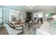 Comfortable living room with hardwood floors, neutral walls, and access to the dining room at 5135 Winding Brook Rd, Charlotte, NC 28226