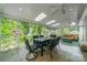 Bright sunroom with skylights, wood floors, and screened windows offering outdoor views at 5135 Winding Brook Rd, Charlotte, NC 28226