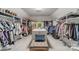 Spacious walk-in closet with ample storage, a center island, seating and carpet flooring at 5135 Winding Brook Rd, Charlotte, NC 28226
