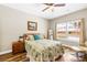 Comfortable bedroom with hardwood floors, a large window with natural light, and neutral-toned walls at 5648 Woodard St, Charlotte, NC 28269
