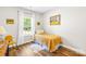 Bright bedroom features hardwood floors, one twin bed, and natural light from the window at 5648 Woodard St, Charlotte, NC 28269