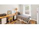 Cozy bedroom with desk area, wood floors, and a striped duvet cover at 5648 Woodard St, Charlotte, NC 28269