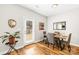 Cozy dining area with hardwood floors, a modern table setting, and a door leading to the outside at 5648 Woodard St, Charlotte, NC 28269